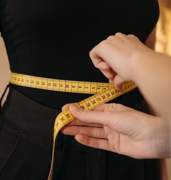 Tailor taking measurements